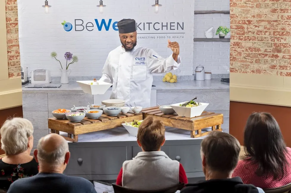 a chef preparing food for senior dining event