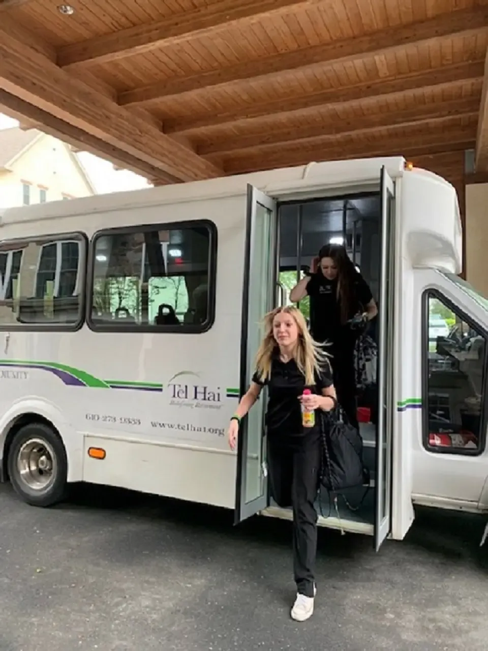 two girls getting off a bus
