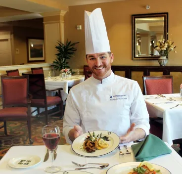 a chef showing the food he prepared