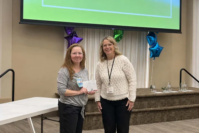 Tami Golab receives a “Caregiver of the Year 2026” Award from AHN Saint Vincent Hospital Chief Operating Officer Karen Surkala.